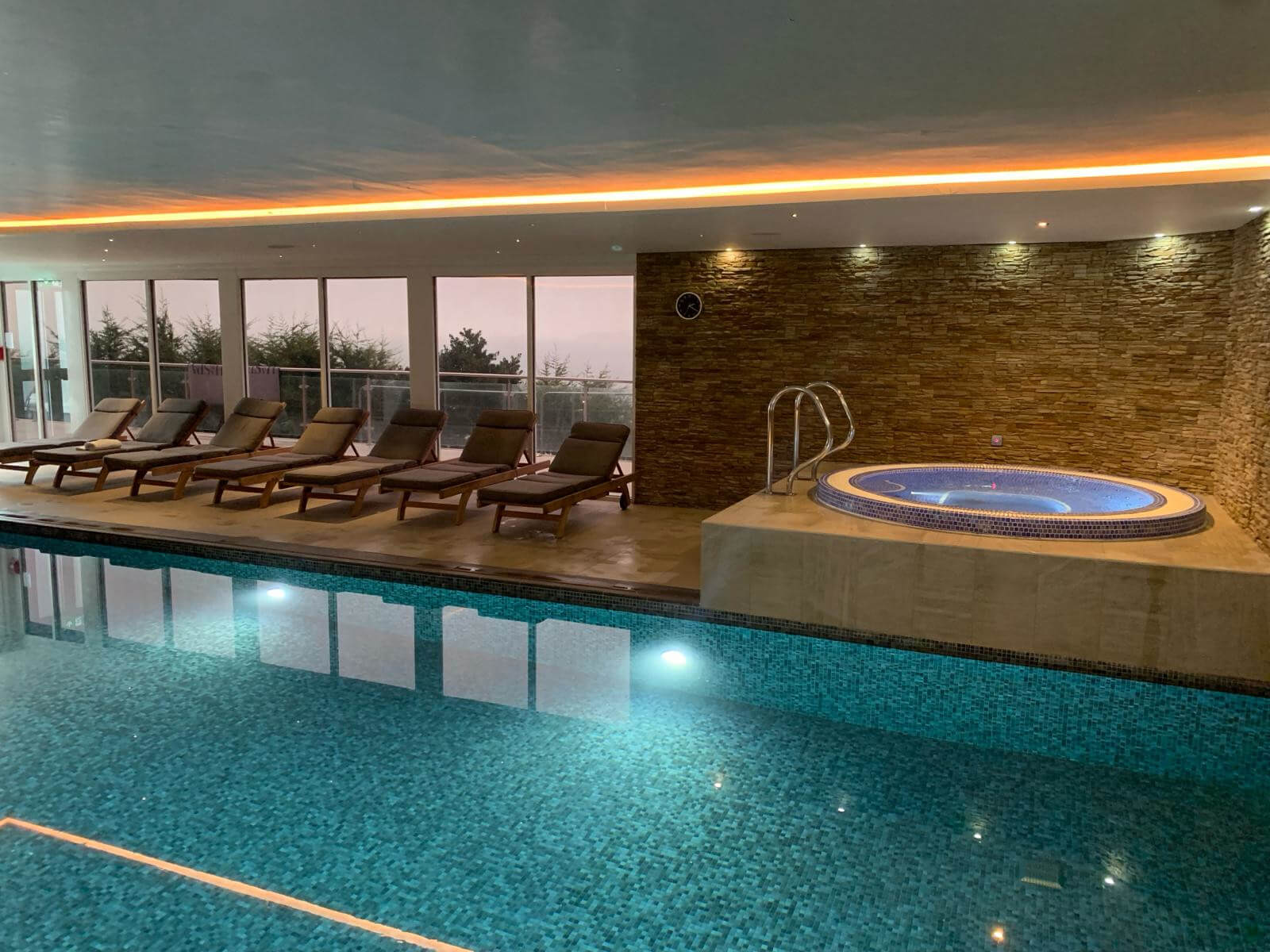 Hot tub with blue tile detail and large pool