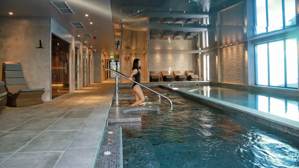 Large swimming pool with lady entering